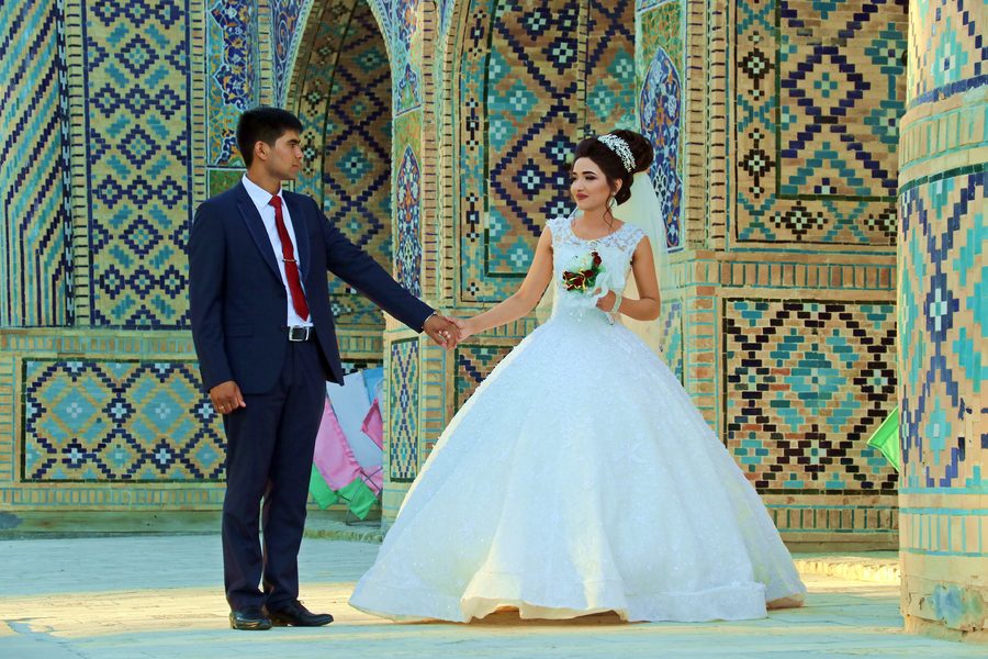 Wedding couple at Bukhara Silk Road tilework, Uzbekistan