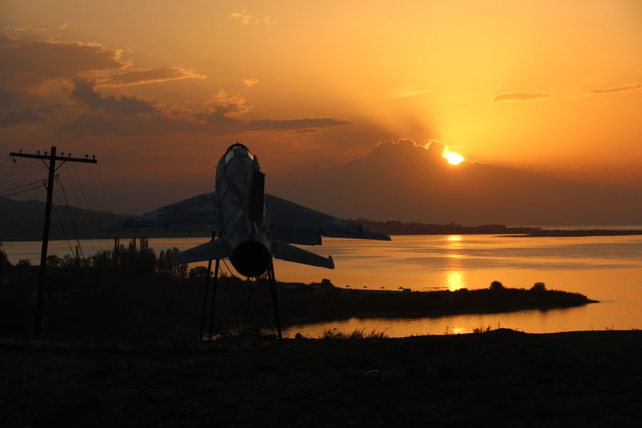 Soviet jet monument silhouette at Issyk-Kul sunset, Kyrgyzstan